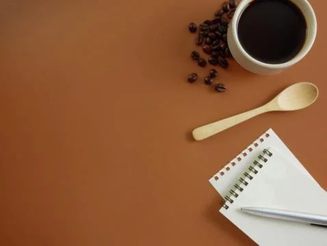 Flat lay brown desk with notebook and coffee Stock Photos