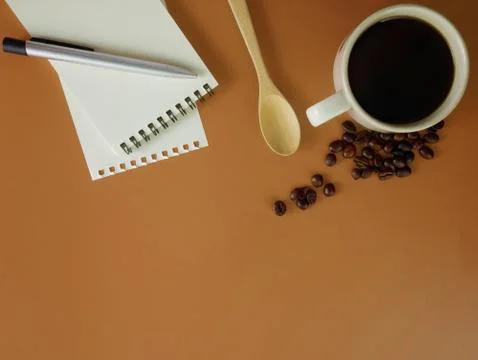 Flat lay brown desk with notebook and coffee Stock Photos