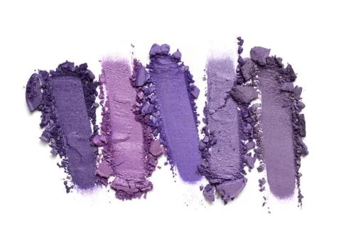 Flat lay of brush strokes. Broken bright eyeshadow as samples of cosmetic bea Stock Photos