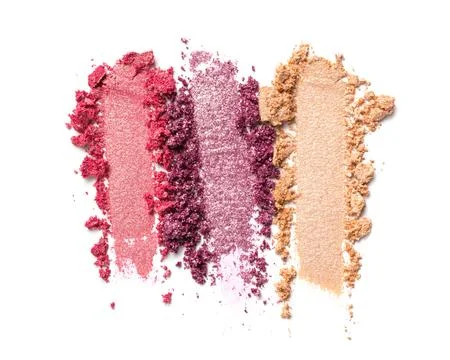 Flat lay of brush strokes. Broken bright color shiny eyeshadow as samples of  Stock Photos