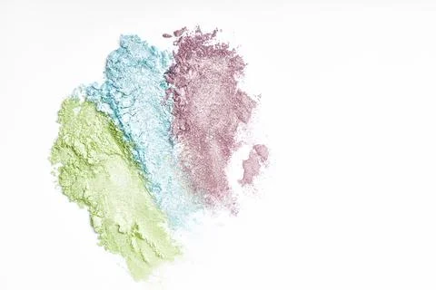 Flat lay of brush strokes. Broken shiny bright eyeshadow as samples of cosmet Stock Photos