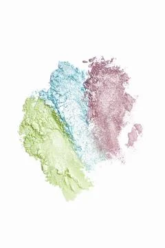 Flat lay of brush strokes. Broken shiny bright eyeshadow as samples of cosmet Stock Photos