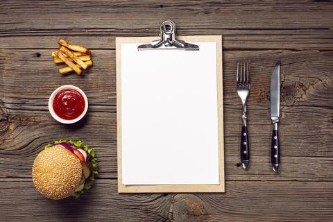 Flat lay burger with mock up clipboard Stock Photos