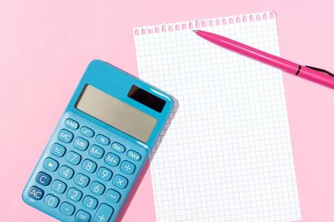 Flat lay of a calculator, blank grid paper notebook and pen on pink background Stock Illustration