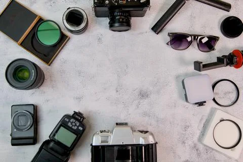 Flat lay with camera lenses and accessories on white background Stock Photos