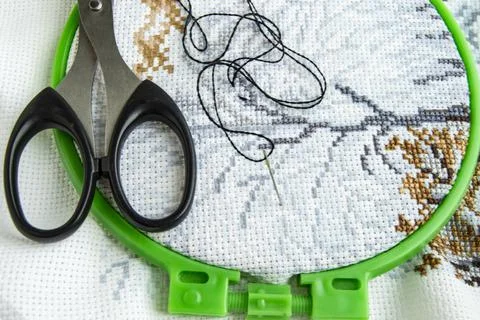 Flat lay canvas with a beautiful pattern of bright sewing threads, scissors and Stock Photos