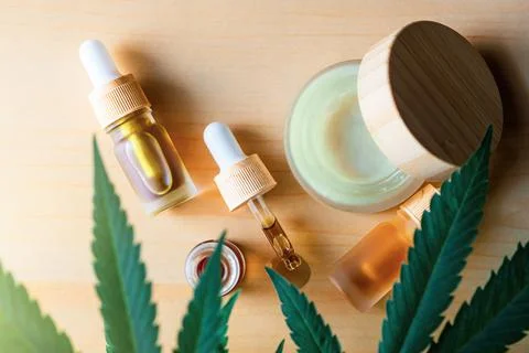 Flat lay CBD cannabis oils and hand Skin cream, alternative medicine hemp pro Stock Photos