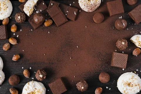 Flat lay chocolate sweets mix cocoa powder pink background with copy space Stock Photos