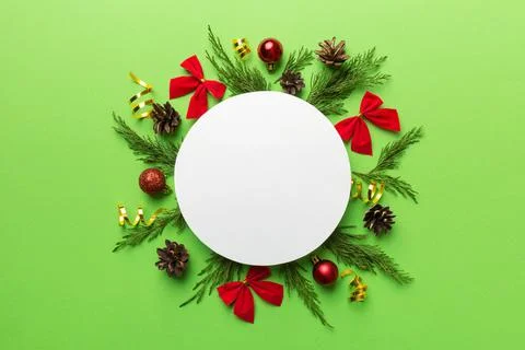 Flat lay Christmas composition. Round Paper blank, pine tree branches, christ Stock Photos
