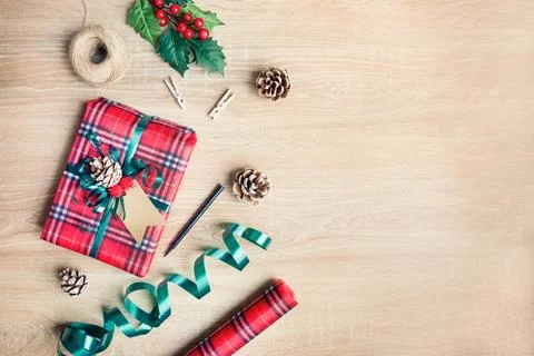 Flat lay of a Christmas gift box wrapped in scottish tartan pattern paper w.. Stock Photos