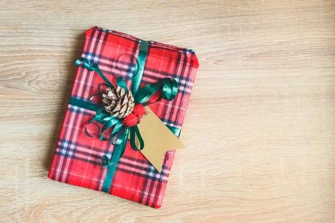 Flat lay of a Christmas gift box wrapped in scottish tartan pattern paper o.. Stock Photos