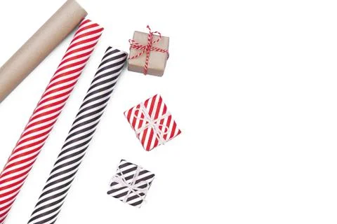 Flat lay with christmas present, wrapping paper, ribbon on white tabletop. Stock Photos