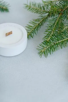 Flat lay Christmas tree Branches and Candle on Light Gray Background at Top o Stock Photos