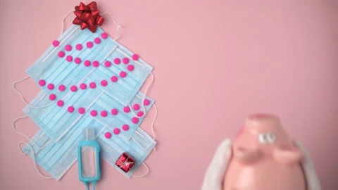 Flat lay with Christmas tree made from medical masks, piggy bank Stock Footage 164793304