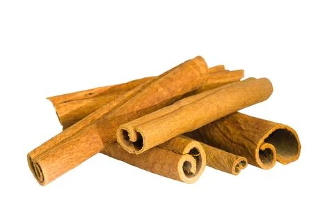 Flat lay of cinnamon bark shards on a white background, capturing their org.. Stock Photos