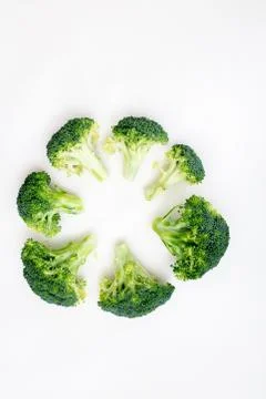 Flat lay circular composition with fresh green broccoli Stock Photos