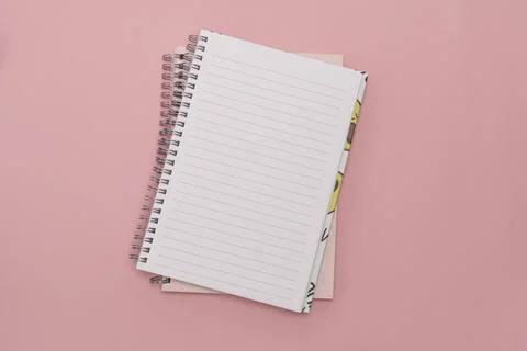 Flat lay, clean notepad on pink background Stock Photos