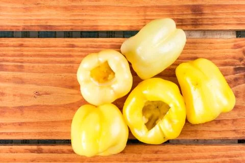 Flat lay cleaned yellow paprika on the wooden table Stock Photos