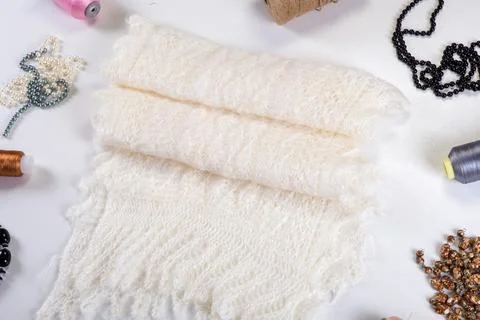 Flat lay closeup on handmade white woolen scarf with diferent accessories Fotos de archivo