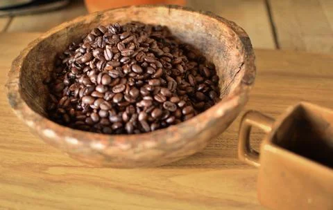 Flat lay- coffee beans on a wooden bowl Stock Photos