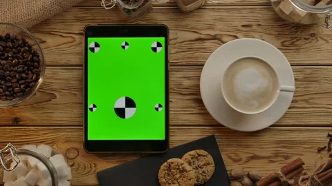 Flat lay coffee break. Tablet oriented vertically with green screen for working Stock Footage 136814255