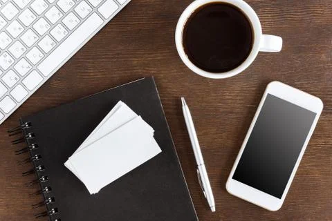 Flat lay with coffee cup, blank cards and wireless devices on workplace 写真素材