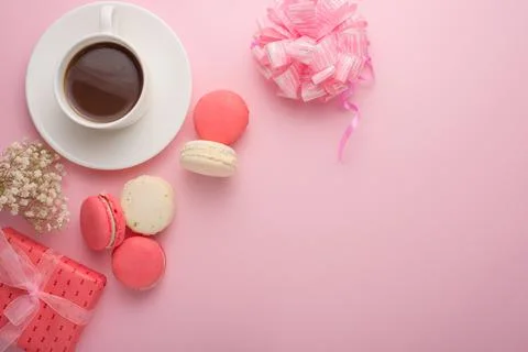Flat-lay coffee with macaroons with a gift and flowers with an empty space fo Stock Photos