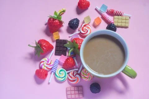 Flat lay coffee mug with chocolate bar, cotton candy and candy ornaments Stock Photos