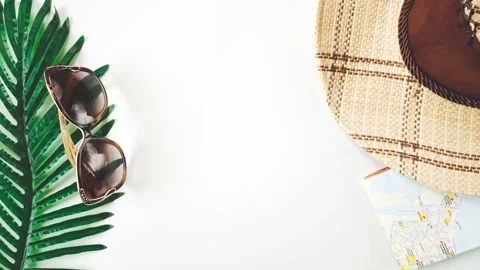 Flat lay collage of map, hat, palm leaf and sunglasses Stock Footage 190799085