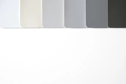 Flat lay color sample cards in shades of white through grey Stock Photos