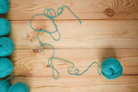 Flat lay of colored wool balls laying on the wooden background. Free space fo Stock-Fotos