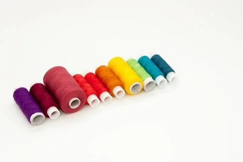 Flat lay with colorful cotton thread spools, embroidery yarn, rainbow bobbins Stock Photos