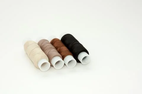 Flat lay colorful cotton thread spools, embroidery yarn, white, brown, black, Stock Photos