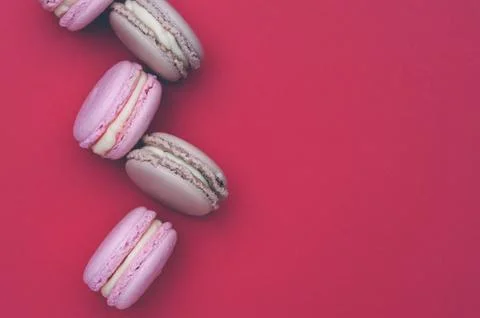 Flat lay colorful macaroons on red background Stock Photos