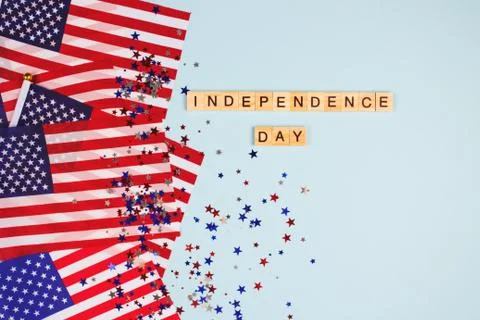 Flat lay composition with american flags, star shaped sparkles and words Stock Photos