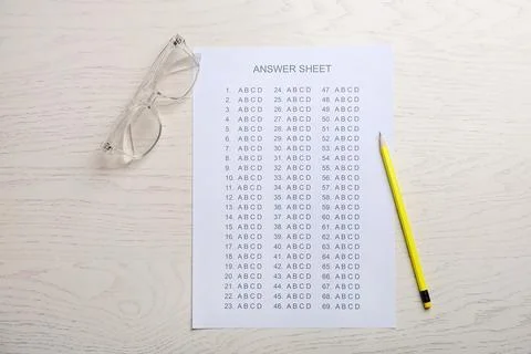 Flat lay composition with answer sheet on wooden background 写真素材
