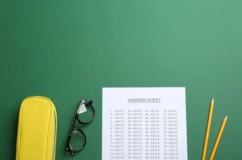 Flat lay composition with answer sheet and space for text on color background 写真素材