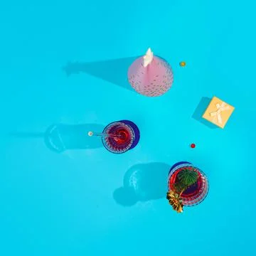 Flat lay composition. Azure blue background with cocktail glasses. Refreshing Stock Photos