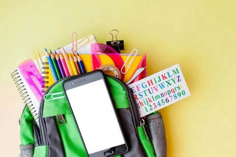 Flat lay composition with backpack and school stationery on yellow background Foto stock