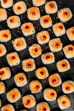 Flat lay composition with baked rolls on a dark background. Stock Photos