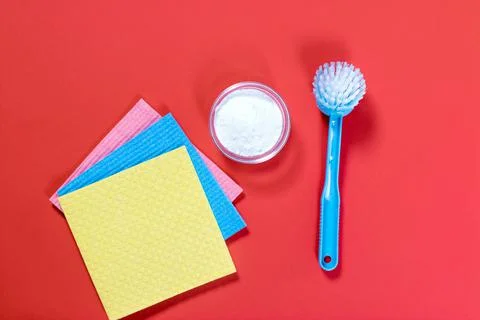 Flat lay composition with baking soda and cleaning supplies on color backgrou Stock Photos