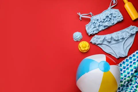 Flat lay composition with ball and beach objects on red background, space for 写真素材