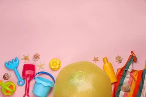Flat lay composition with beach ball and sand toys on pink background. Space  写真素材