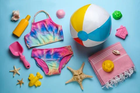 Flat lay composition with beach ball and sand toys on light blue background 写真素材