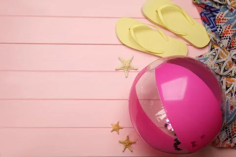 Flat lay composition with beach ball on pink wooden background. Space for tex 写真素材