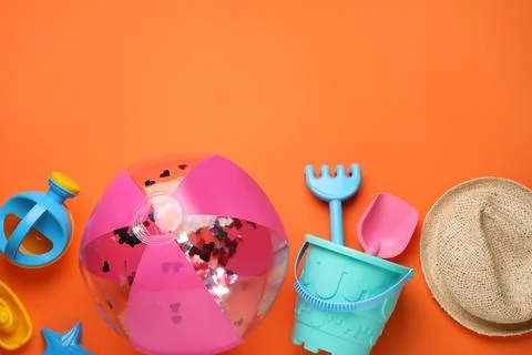 Flat lay composition with beach ball and sand toys on orange background, spac 写真素材