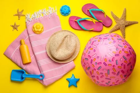Flat lay composition with beach ball and sand toys on yellow background 写真素材