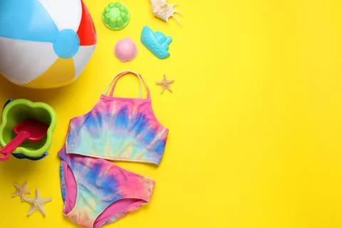Flat lay composition with beach ball and sand toys on yellow background, spac 写真素材