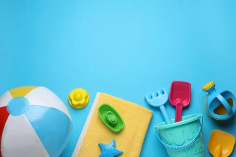 Flat lay composition with beach ball and sand toys on light blue background,  写真素材