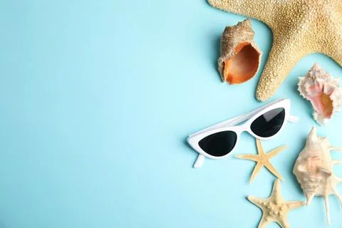 Flat lay composition with beach objects on blue background. Space for text Stock Photos